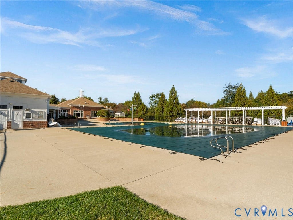 5726 Gossamer Place, Wynwood At FoxCreek, Moseley, VA 23120 Outdoor swimming pool with a safety cover, concrete decking, metal railings, and a wooden pergola structure