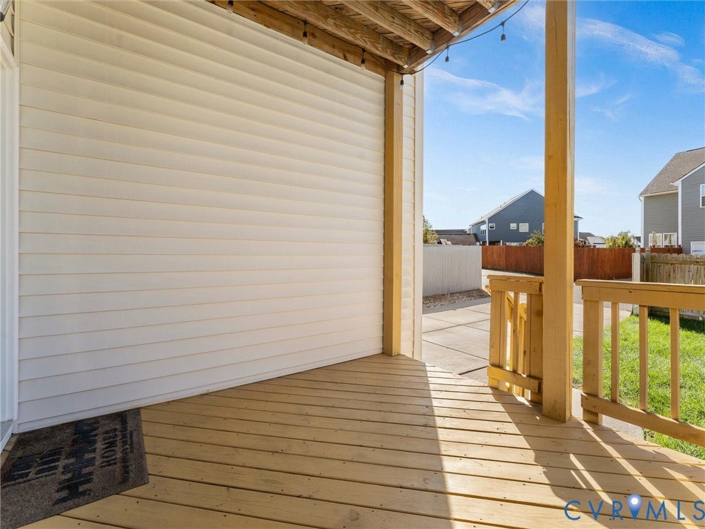 5726 Gossamer Place, Wynwood At FoxCreek, Moseley, VA 23120 Covered wooden deck featuring horizontal siding, natural wood support posts, and wooden railing