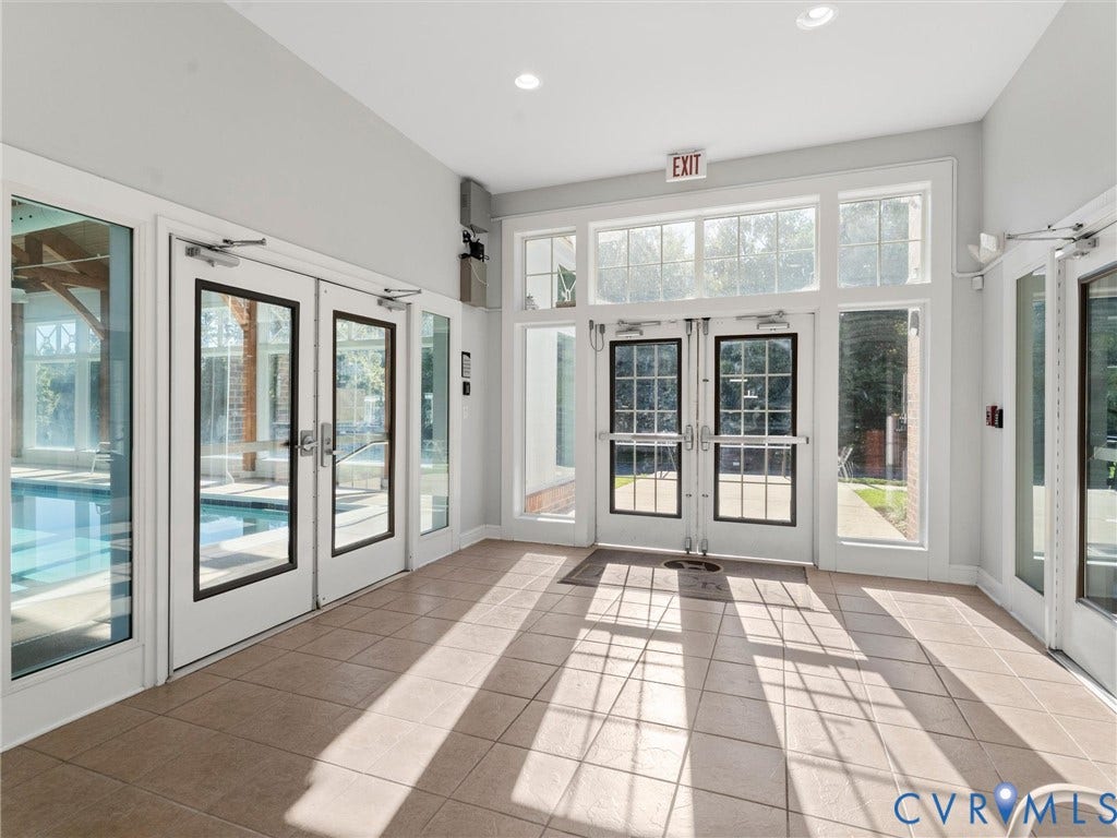 5726 Gossamer Place, Wynwood At FoxCreek, Moseley, VA 23120 Ceramic tile flooring, multiple sets of white-framed glass paneled doors, recessed lighting, and extensive window transoms