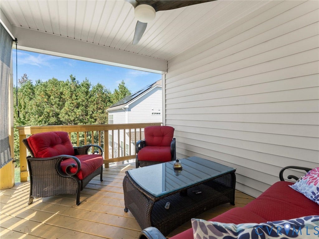 5726 Gossamer Place, Wynwood At FoxCreek, Moseley, VA 23120 Covered deck featuring horizontal siding, wood-plank flooring, and a ceiling-mounted fan