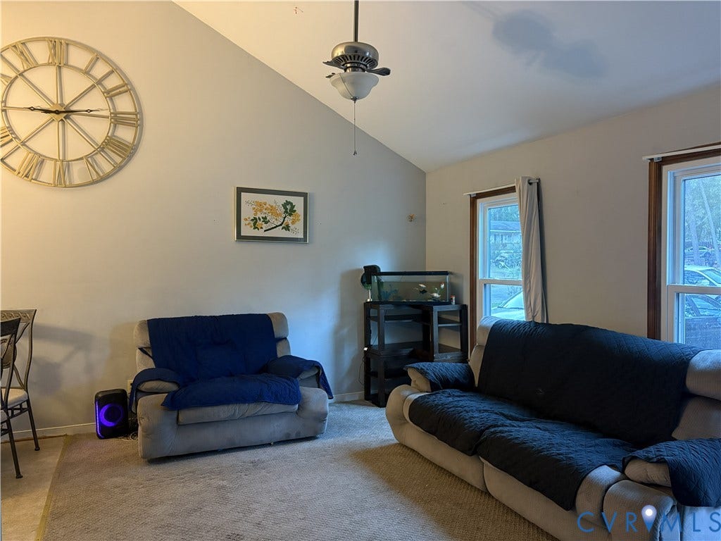 3207 Roland View Terrace, Chester, VA 23831 Vaulted ceiling featuring a central brushed-nickel ceiling fan with integrated light fixture and dual windows with wooden trim