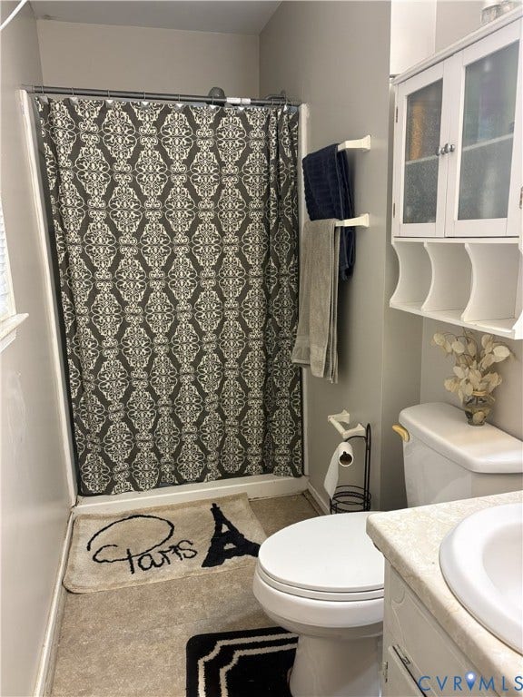 3207 Roland View Terrace, Chester, VA 23831 Full bathroom featuring a shower-tub combination, white vanity with an integrated basin, and wall-mounted cabinetry with glass-paneled doors
