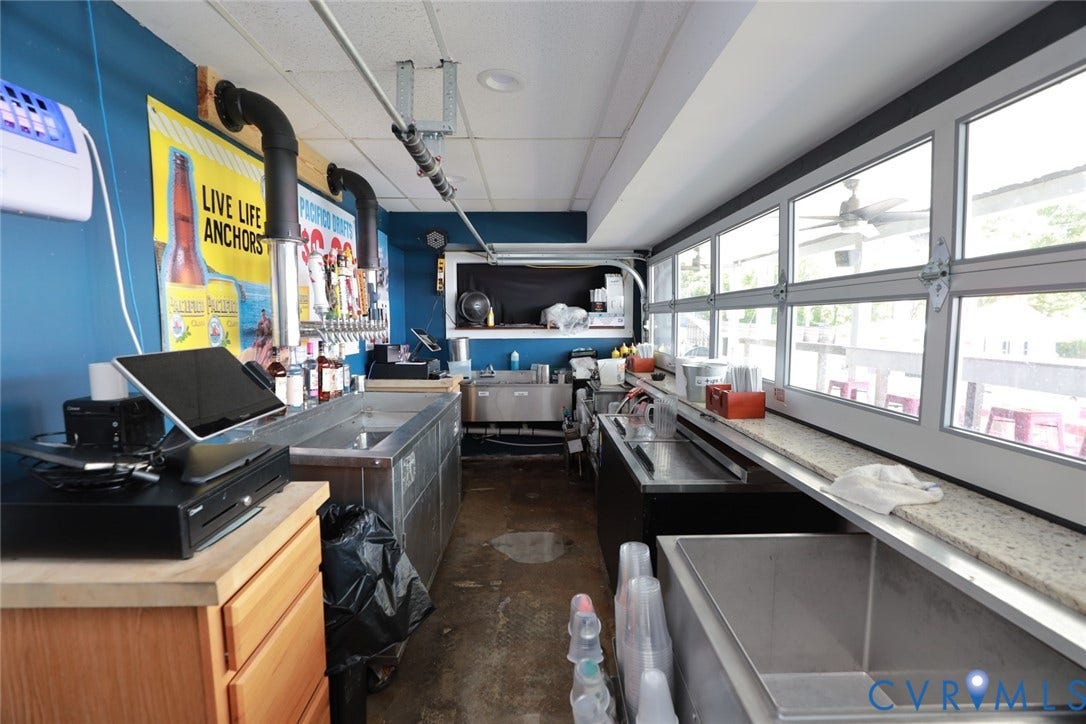 700 Jordan Point Road, North Prince George, VA 23860 Service station featuring stainless steel multi-compartment sinks, expansive multi-pane windows with horizontal tracks, multi-tap beer dispensing system, and heavy-duty industrial flooring