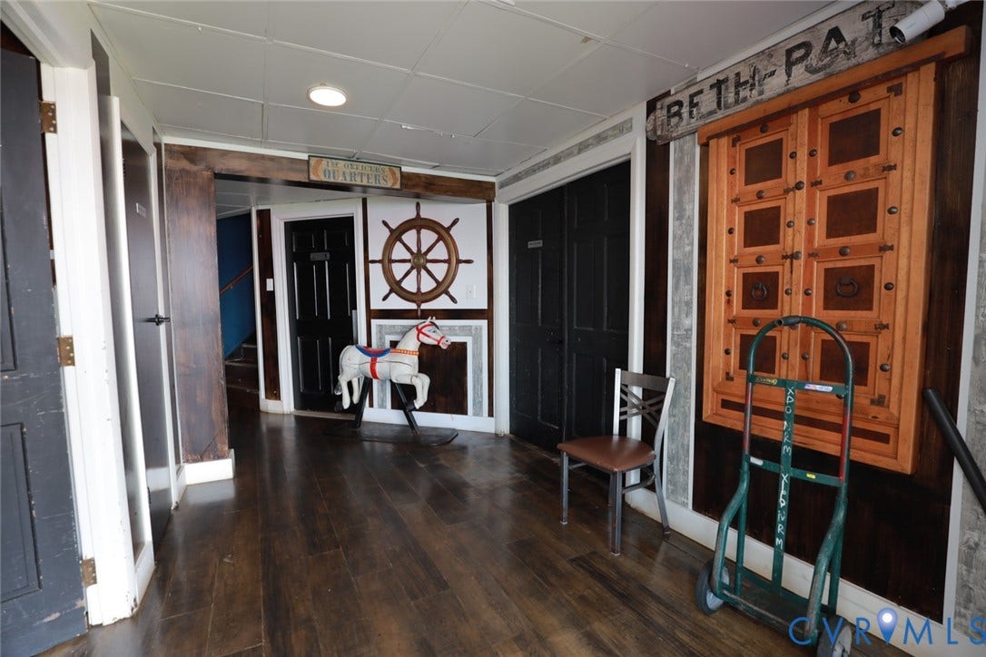 700 Jordan Point Road, North Prince George, VA 23860 Hallway featuring dark wood-finish flooring, recessed ceiling lighting, decorative timber wall paneling, and custom carved wooden wall accents