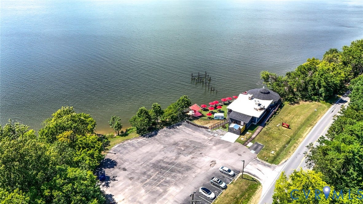 700 Jordan Point Road, North Prince George, VA 23860 Waterfront property featuring direct access to the shore, an expansive paved parking area, and mature perimeter trees