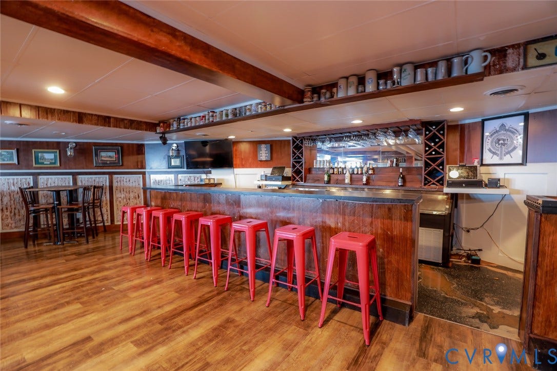 700 Jordan Point Road, North Prince George, VA 23860 Built-in wet bar featuring wood cabinetry, integrated glass stemware rack, wine storage, and recessed lighting