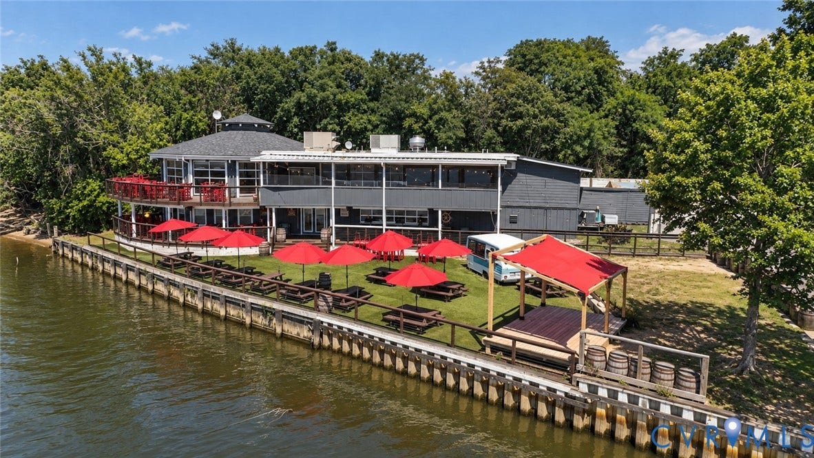 700 Jordan Point Road, North Prince George, VA 23860 Waterfront property featuring a bulkhead, expansive lawn, multi-level exterior decking, and a covered wooden structure