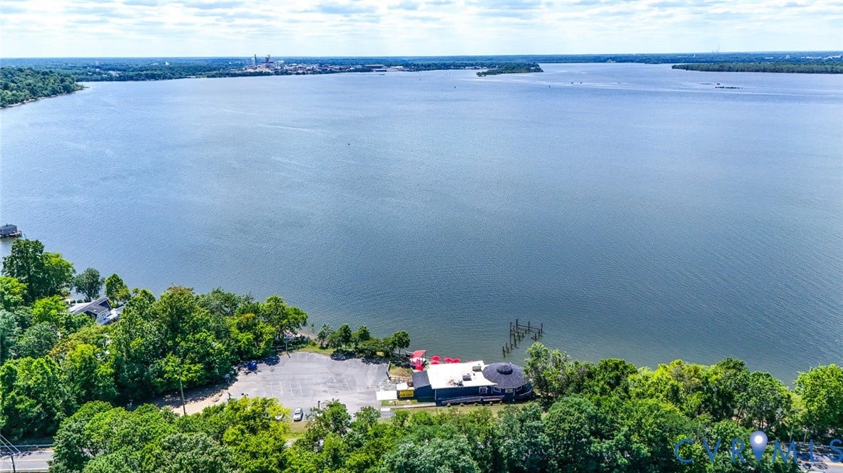 700 Jordan Point Road, North Prince George, VA 23860 Waterfront property featuring an expansive shoreline, mature tree canopy, and direct open-water access