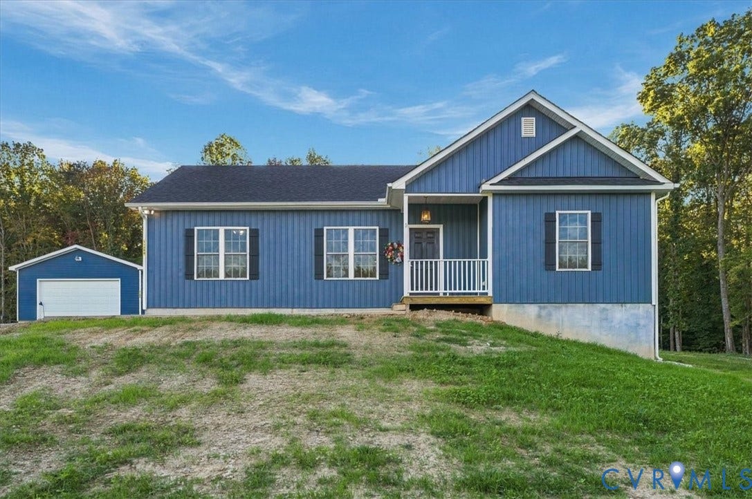 11880 Fosters Lane, Amelia, VA 23002 Expansive open grounds featuring a blue-sided outbuilding, a gravel driveway, and a border of mature trees