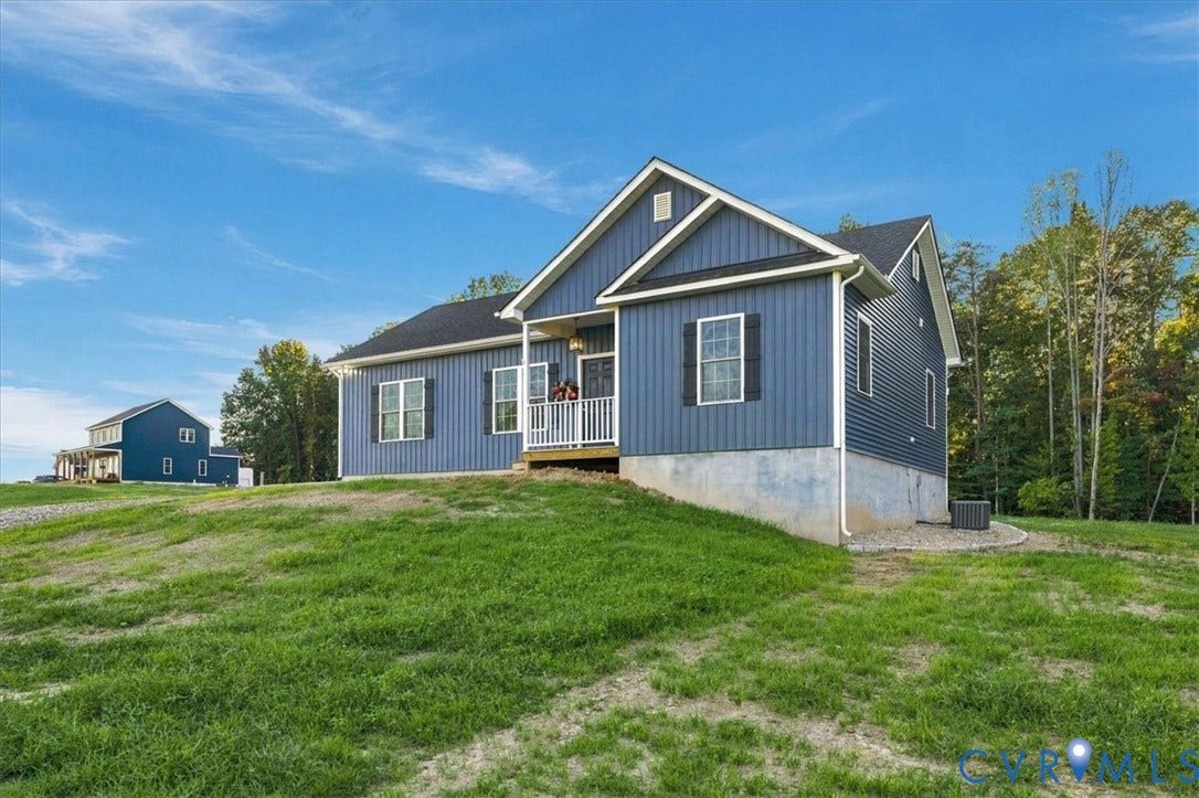 11880 Fosters Lane, Amelia, VA 23002 Single-story residence featuring vertical siding, a front porch with railing, decorative window shutters, and a concrete foundation