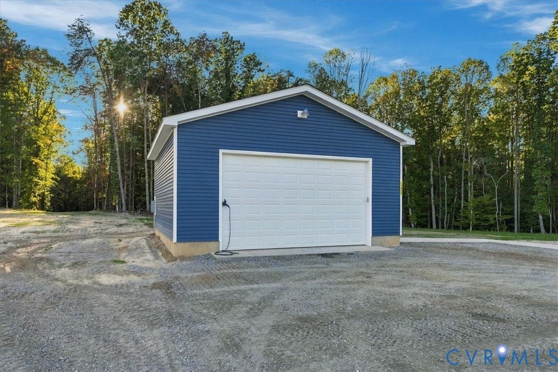 11880 Fosters Lane, Amelia, VA 23002 Expansive outdoor space featuring a paved concrete landing, gravel hardscaping, and mature trees