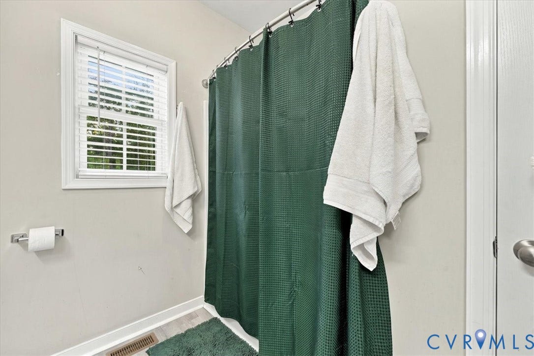 11880 Fosters Lane, Amelia, VA 23002 Bathroom featuring a double-hung window with white faux-wood blinds and a metal tension shower rod