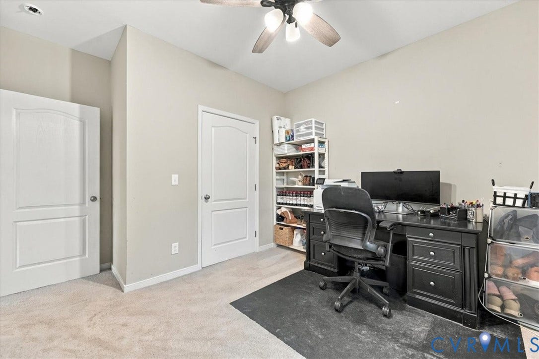 11880 Fosters Lane, Amelia, VA 23002 Open-concept kitchen featuring an island with stone-finish countertop, white cabinetry, stainless steel appliances, wood-finish flooring, and vaulted ceilings