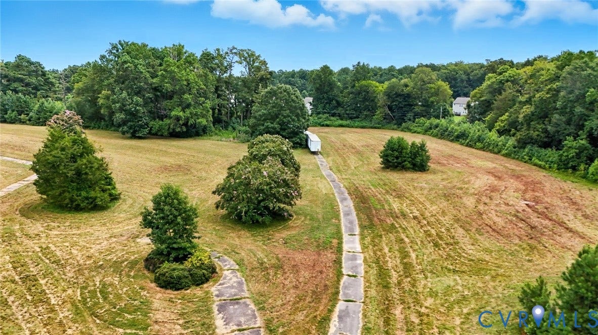 1100 Jordan Point Road, North Prince George, VA 23860 Expansive acreage featuring cleared pasture, paved driveway access, and mature tree buffers