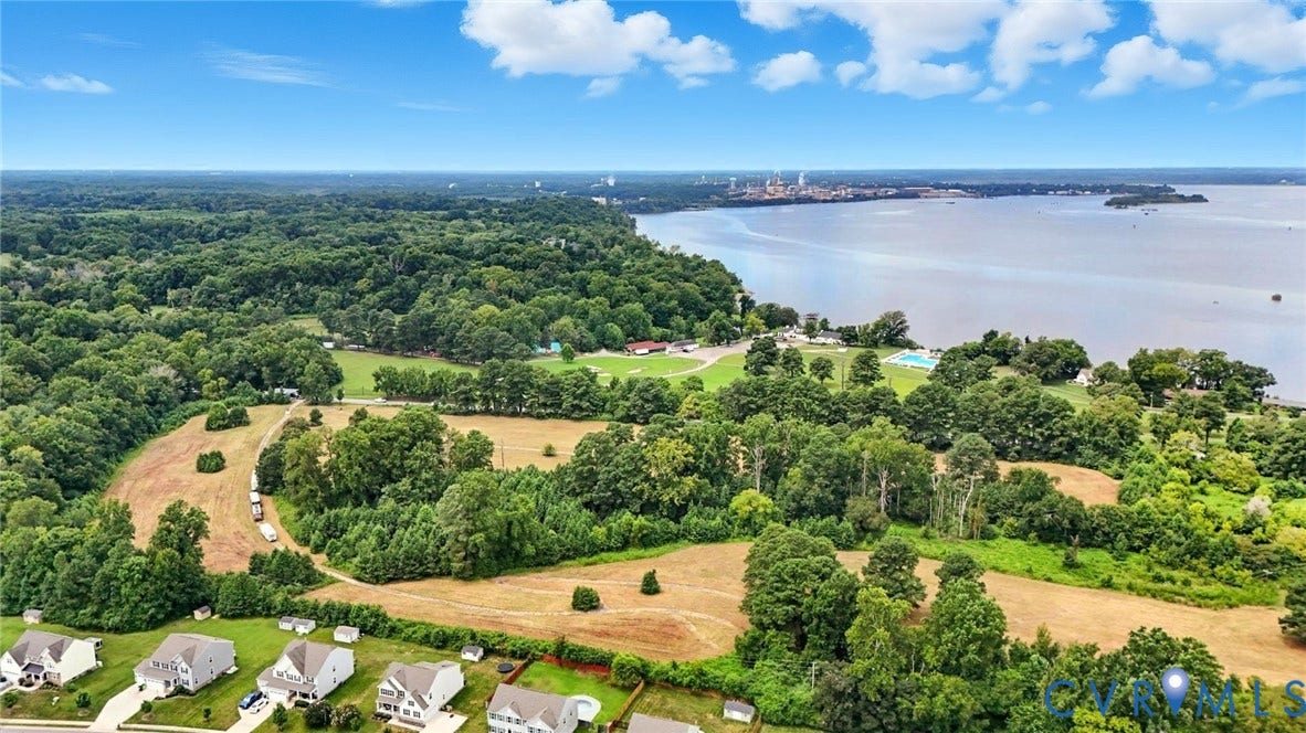 1100 Jordan Point Road, North Prince George, VA 23860 Aerial perspective featuring expansive acreage, mature tree clusters, and direct water frontage