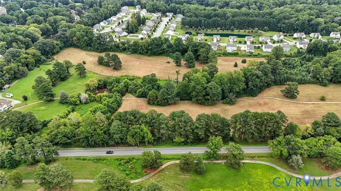 1100 Jordan Point Road, North Prince George, VA 23860 Expansive parcel of land featuring mature trees, open grassy areas, and a multi-use paved path