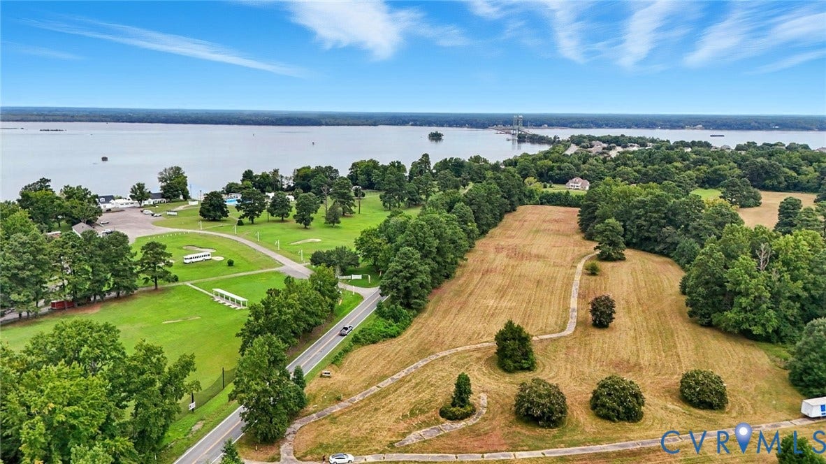 1100 Jordan Point Road, North Prince George, VA 23860 Aerial perspective of expansive acreage featuring mature trees, a meandering paved path, and direct proximity to a large body of water