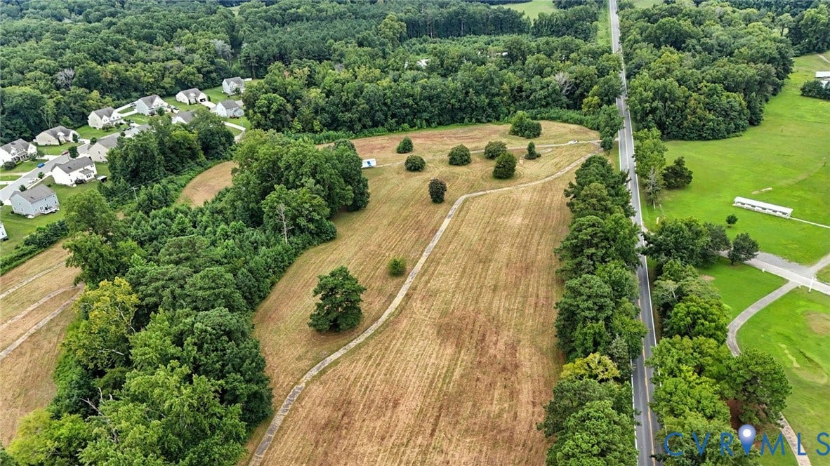1100 Jordan Point Road, North Prince George, VA 23860 Expansive parcel of land featuring cleared acreage, mature tree borders, and paved road access