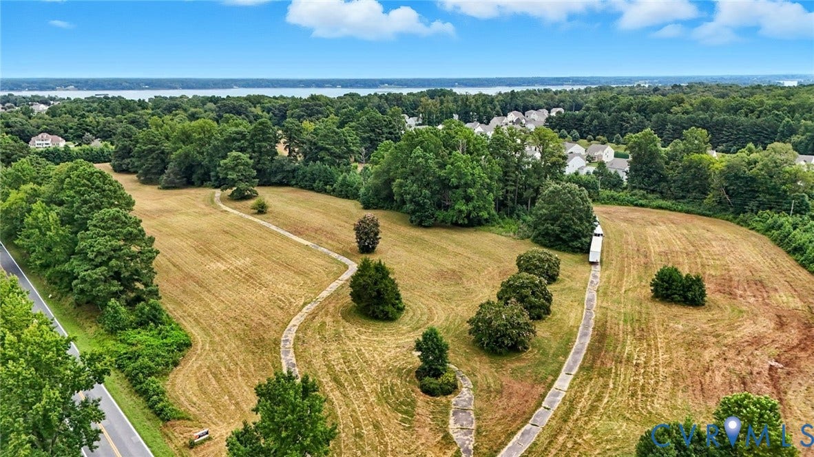 1100 Jordan Point Road, North Prince George, VA 23860 Expansive acreage featuring mature trees, concrete pathways, and surrounding natural greenery