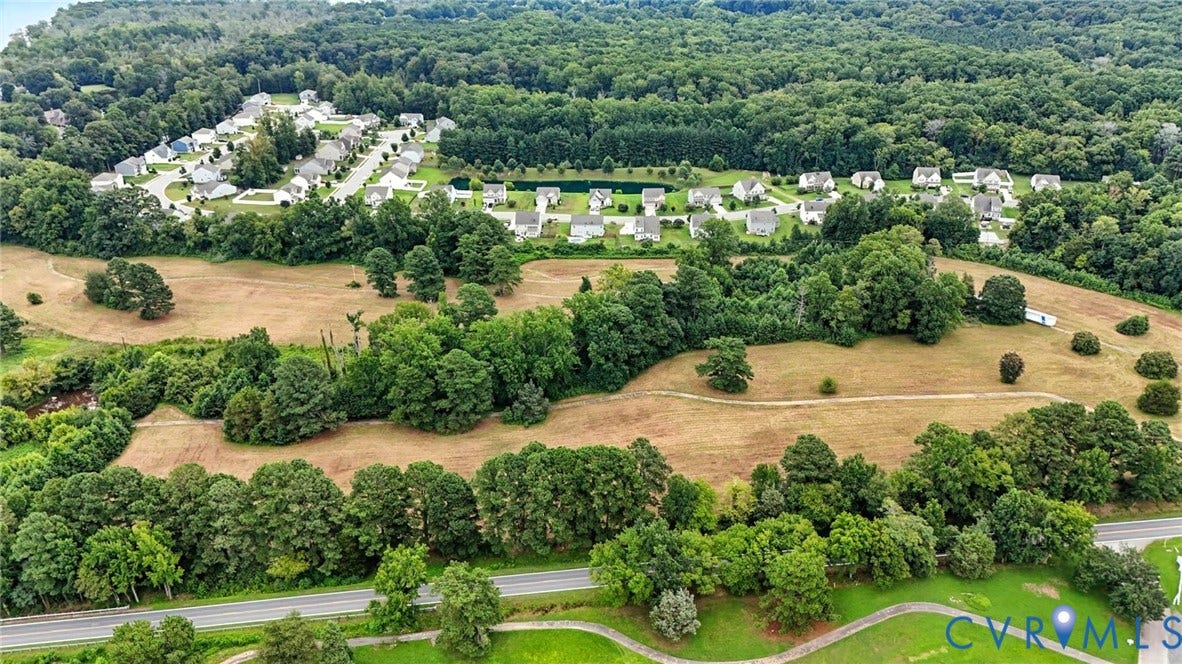1100 Jordan Point Road, North Prince George, VA 23860 Aerial perspective of expansive acreage featuring mature hardwood tree stands, cleared open fields, and established perimeter vegetation