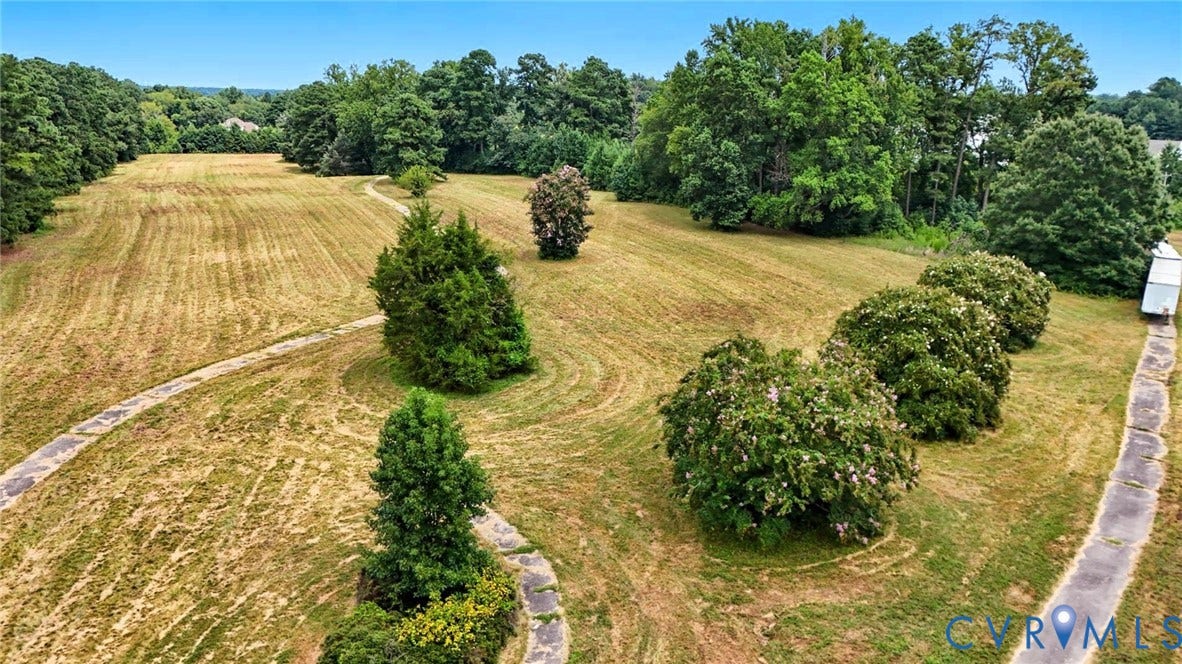1100 Jordan Point Road, North Prince George, VA 23860 Expansive acreage featuring mature trees, sweeping grassy terrain, and winding concrete pathways