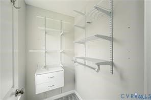 1324 Stone Ridge Park Loop, Henrico, VA 23228 Storage area featuring a two-drawer white built-in cabinet and integrated wall-mounted wire shelving with hanging rods