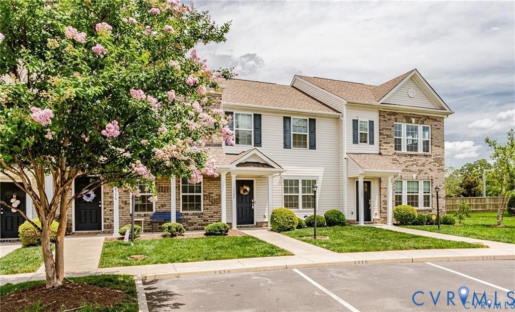 1324 Stone Ridge Park Loop, Henrico, VA 23228 Townhome exterior featuring a combination of horizontal siding and brick masonry, gabled rooflines, covered entries with columns, and shuttered windows