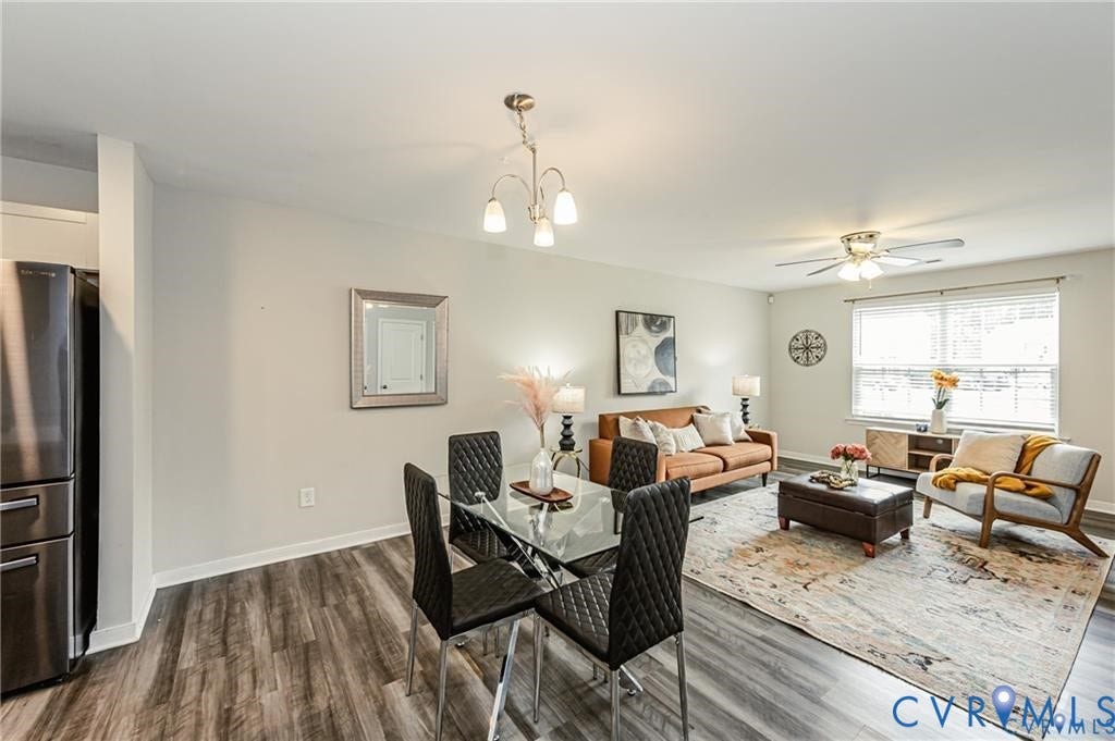 1324 Stone Ridge Park Loop, Henrico, VA 23228 Open-concept living space featuring wood-finish flooring, a multi-bulb chandelier, a ceiling fan with integrated lighting, and neutral wall paint