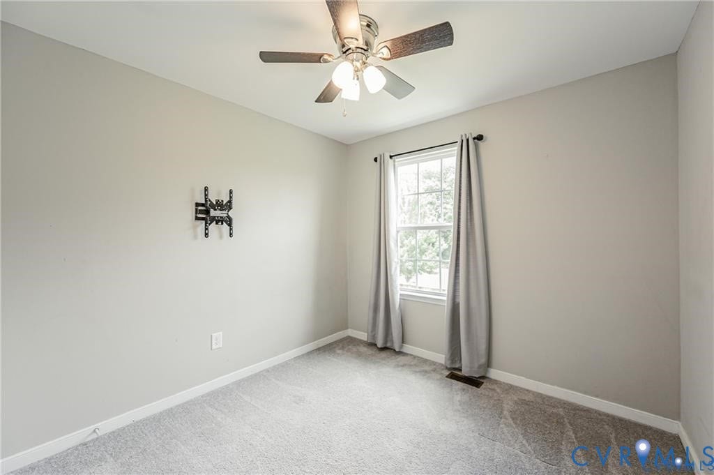 1324 Stone Ridge Park Loop, Henrico, VA 23228 Neutral-toned room featuring wall-to-wall carpeting, a multi-light ceiling fan, a window with an integrated curtain rod, and a wall-mounted bracket