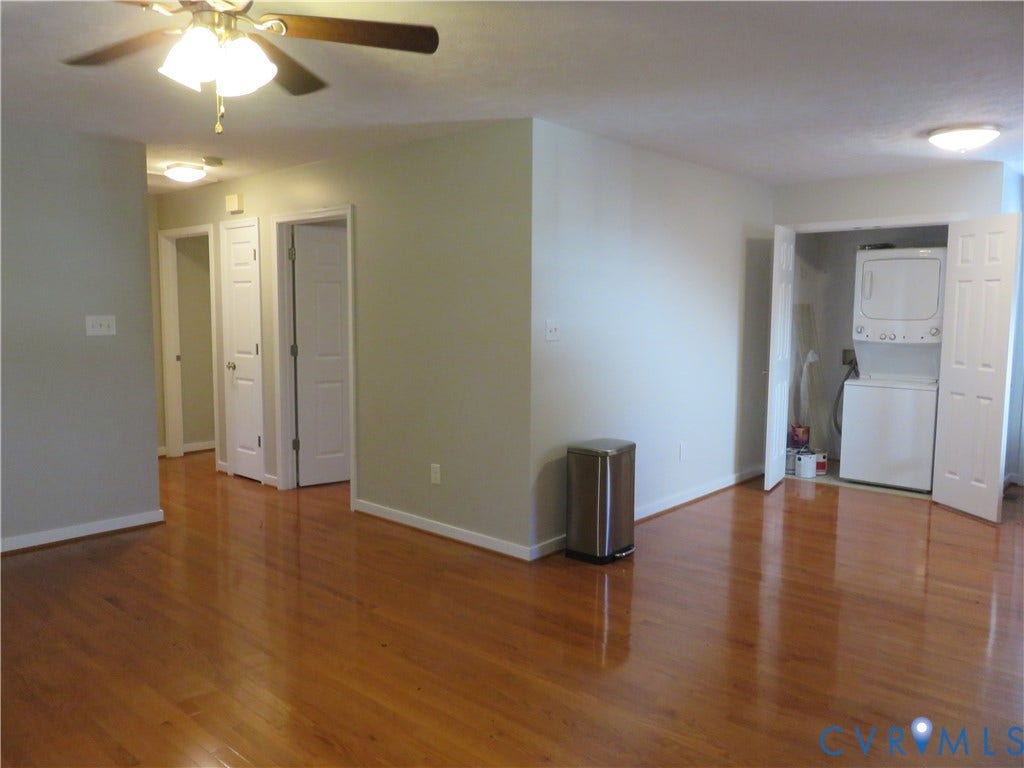 14 N Kalmia Avenue, Henrico, VA 23075 Interior featuring wood-finish flooring, ceiling fan with integrated lighting, multiple paneled doors, and a laundry closet with stacked laundry appliances