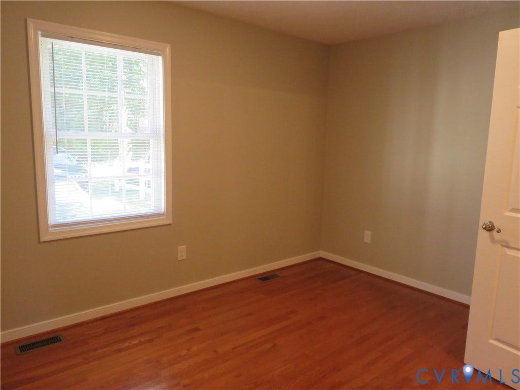 14 N Kalmia Avenue, Henrico, VA 23075 Interior room featuring wood-finish flooring, neutral wall paint, and a single-pane window with white trim