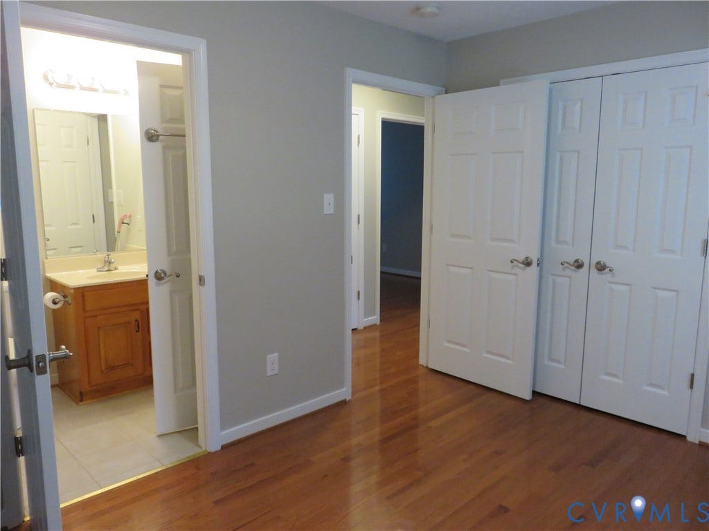 14 N Kalmia Avenue, Henrico, VA 23075 Wood-finish flooring, white six-panel interior doors, and dual-door closet storage