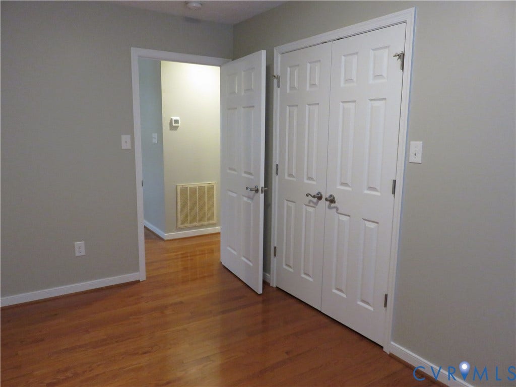 14 N Kalmia Avenue, Henrico, VA 23075 Wood-finish flooring, white six-panel interior doors, and double-door closet with satin-finish hardware
