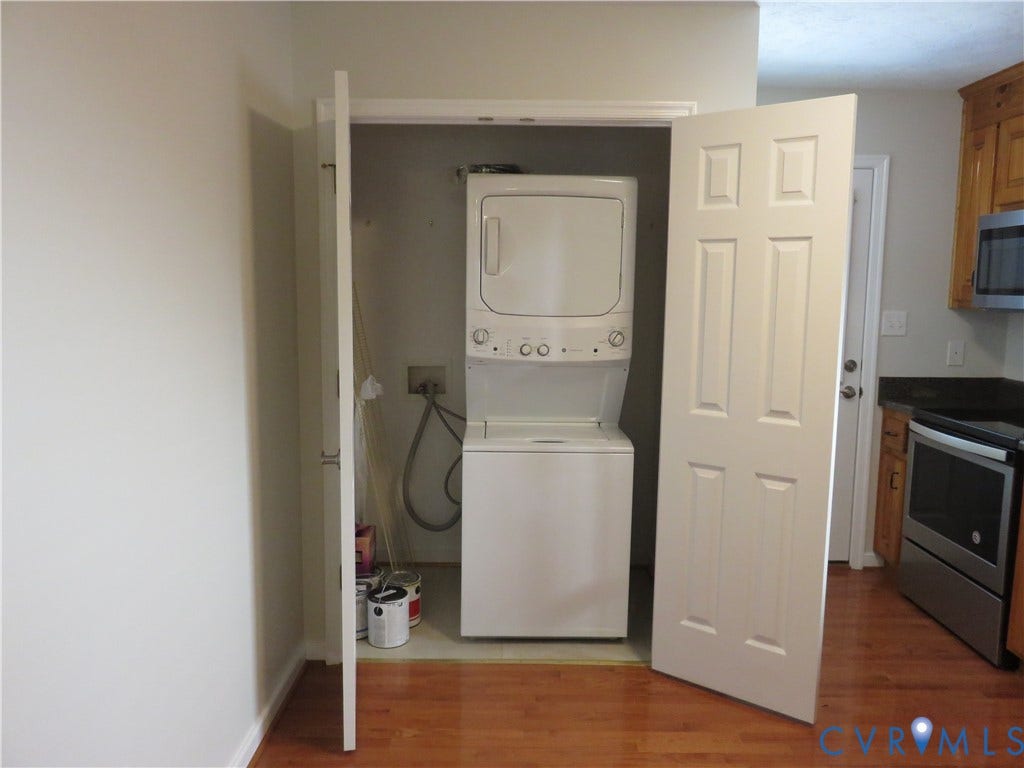 14 N Kalmia Avenue, Henrico, VA 23075 Laundry closet featuring a stackable washer and dryer unit and white six-panel bi-fold doors