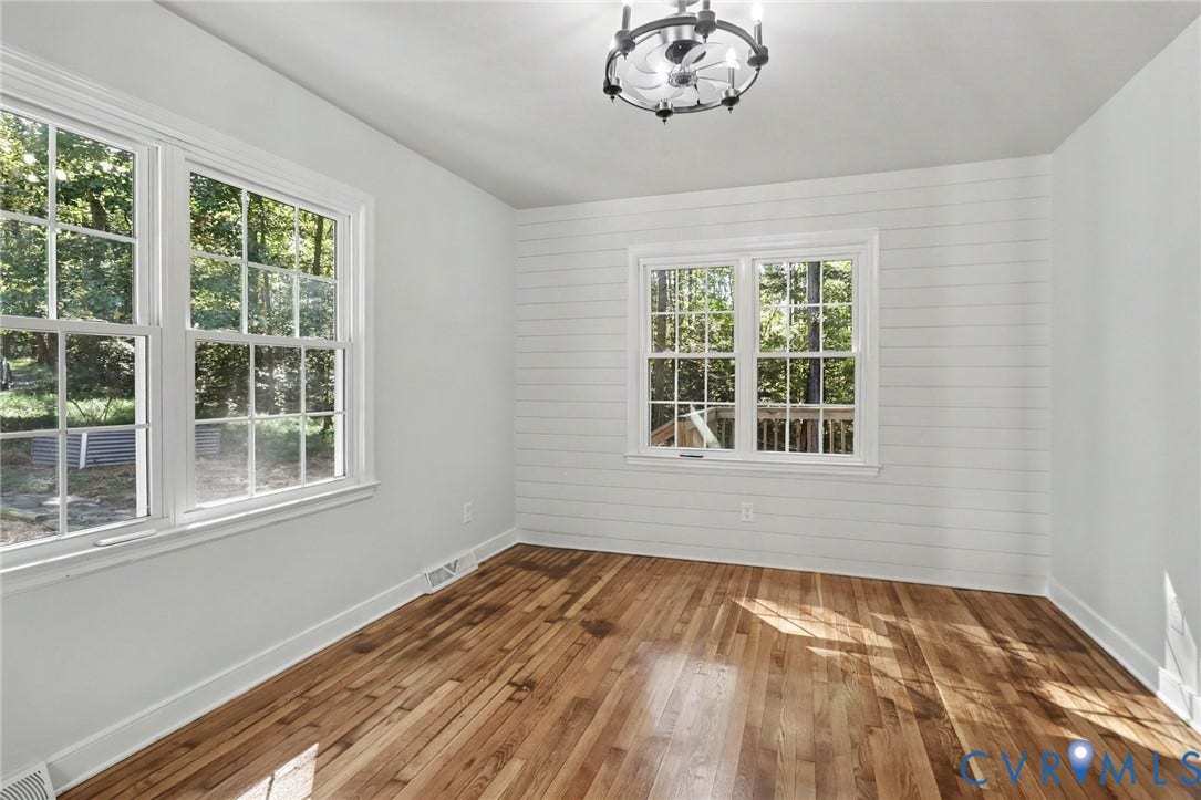 2511 Mill Road, Powhatan, VA 23139 Room featuring wood-finish flooring, shiplap wall detailing, multi-pane windows, and a decorative ceiling fixture