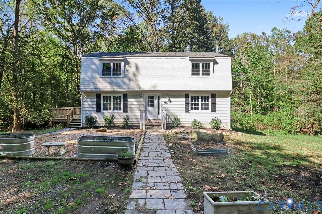 2511 Mill Road, Powhatan, VA 23139 Two-story exterior featuring light-toned horizontal siding, a Gambrel roofline, stone-style paver walkway, and an attached side deck