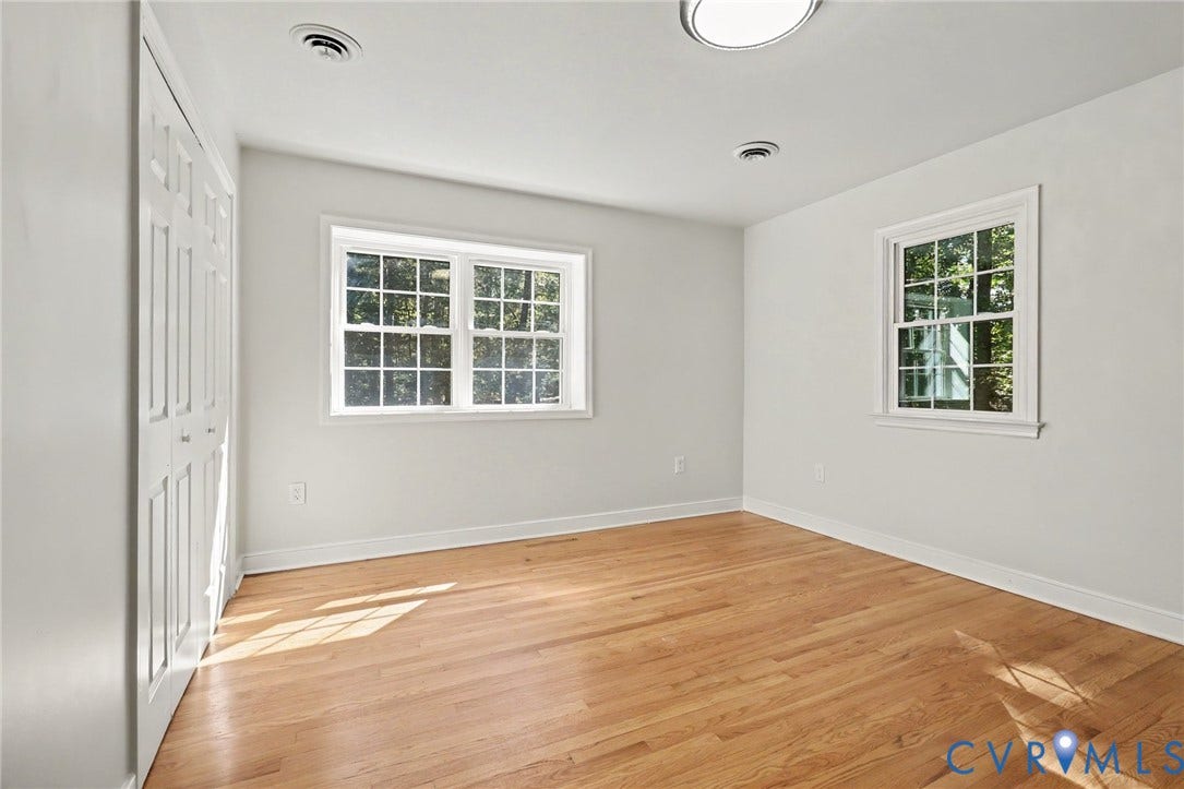 2511 Mill Road, Powhatan, VA 23139 Neutral-toned interior featuring wood-finish flooring, multi-pane windows, and double-door closet cabinetry
