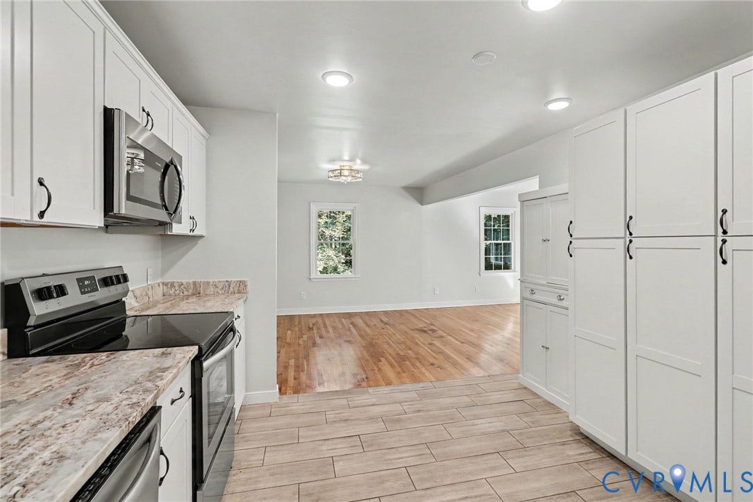 2511 Mill Road, Powhatan, VA 23139 Kitchen featuring white shaker-style cabinetry, stone-pattern laminate countertops, stainless steel appliances, tile flooring, and wood-finish flooring