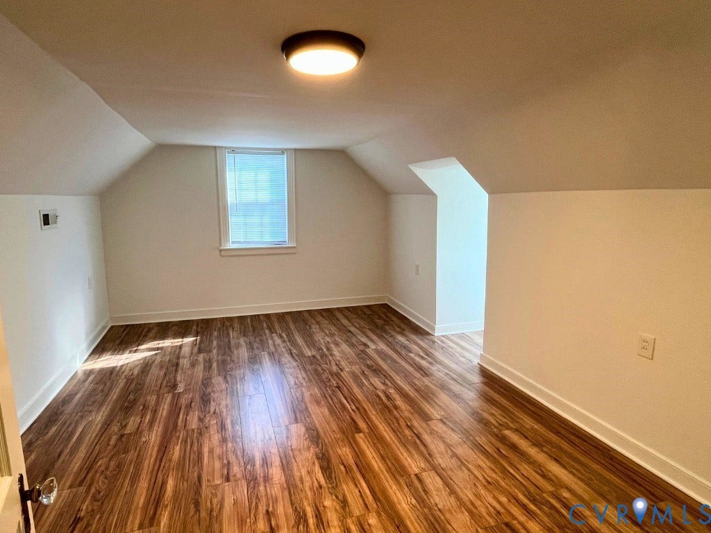 LVP flooring vaulted ceilings, and flush-mount lighting