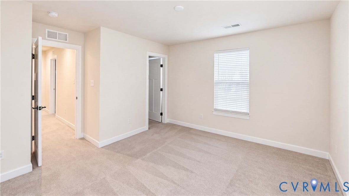 11500 Amara Drive, Chesterfield, VA 23838 Neutral interior room with plush wall-to-wall carpeting, crisp off-white walls, white trim detailing, and a double-hung window featuring built-in blinds