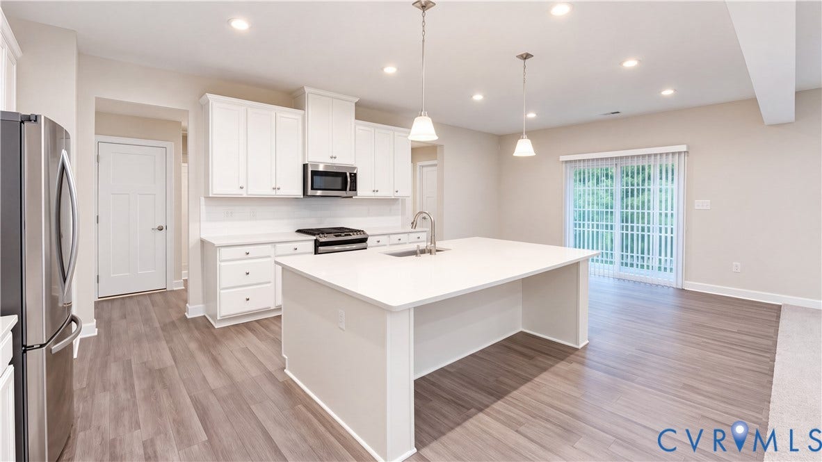 11500 Amara Drive, Chesterfield, VA 23838 Kitchen featuring white shaker-style cabinetry, center island with stone-finish countertop, stainless steel appliances, recessed lighting, and wood-finish flooring