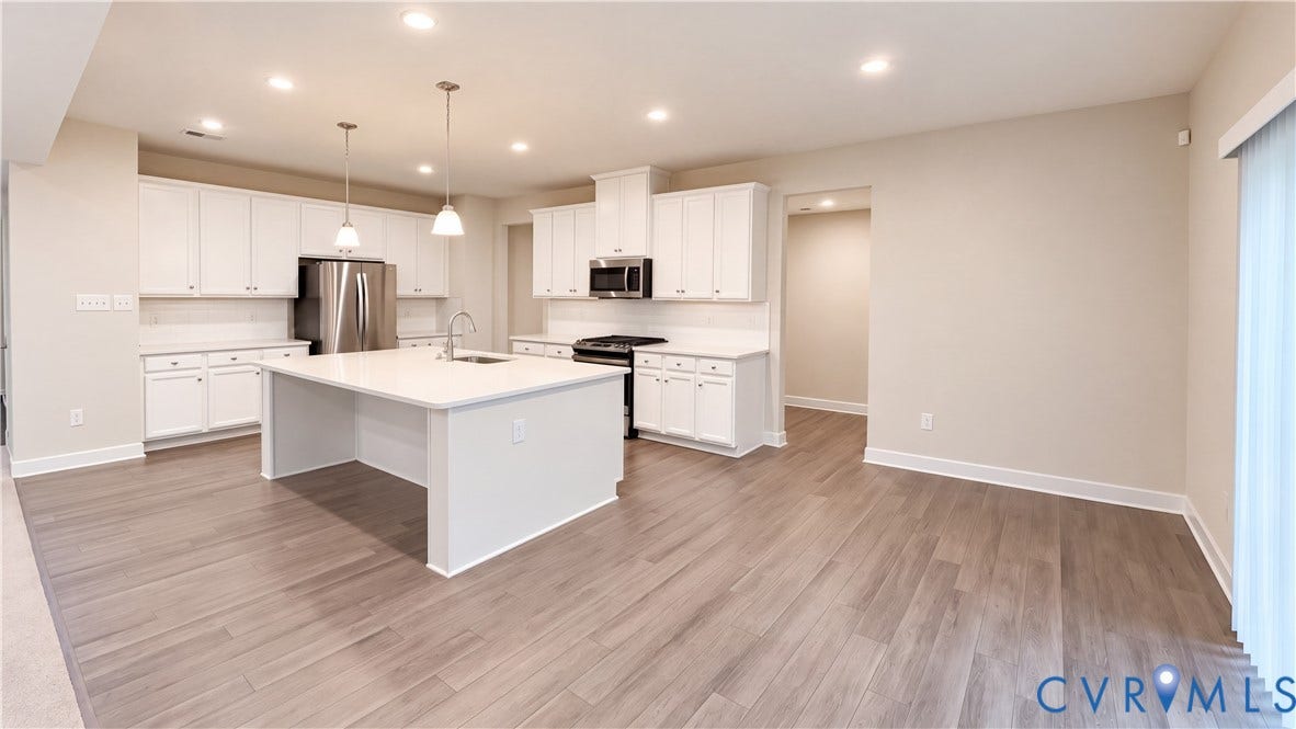 11500 Amara Drive, Chesterfield, VA 23838 Kitchen featuring white cabinetry, a center island with a stone-surface countertop, wood-finish flooring, stainless steel appliances, and recessed ceiling lighting