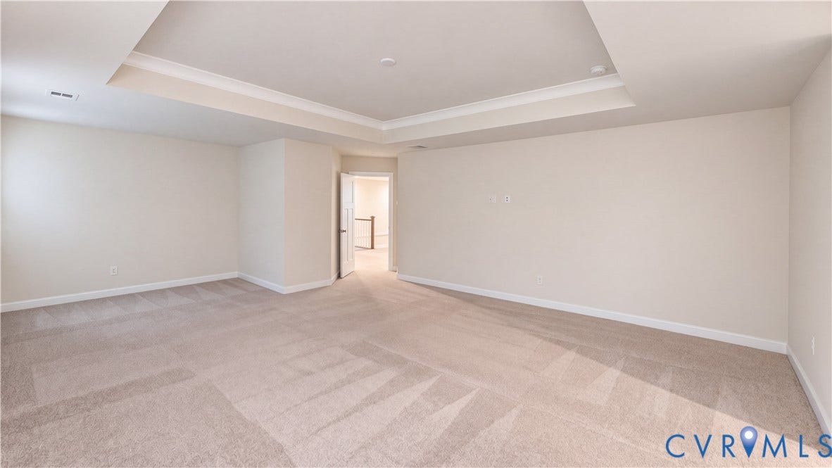 11500 Amara Drive, Chesterfield, VA 23838 Spacious interior room featuring a tray ceiling, neutral wall tones, and wall-to-wall carpeting