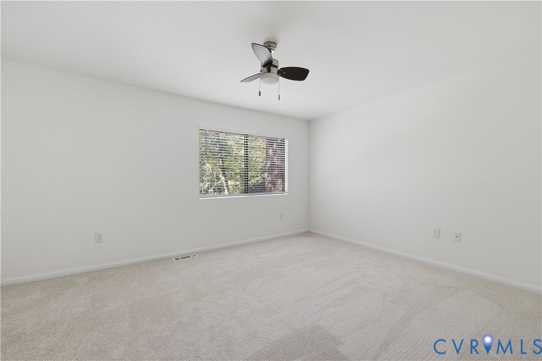 11947 W Briar Patch Drive, Chesterfield, VA 23113 Neutral interior room featuring neutral carpeting, a central ceiling fan with integrated lighting, and a window with horizontal blinds