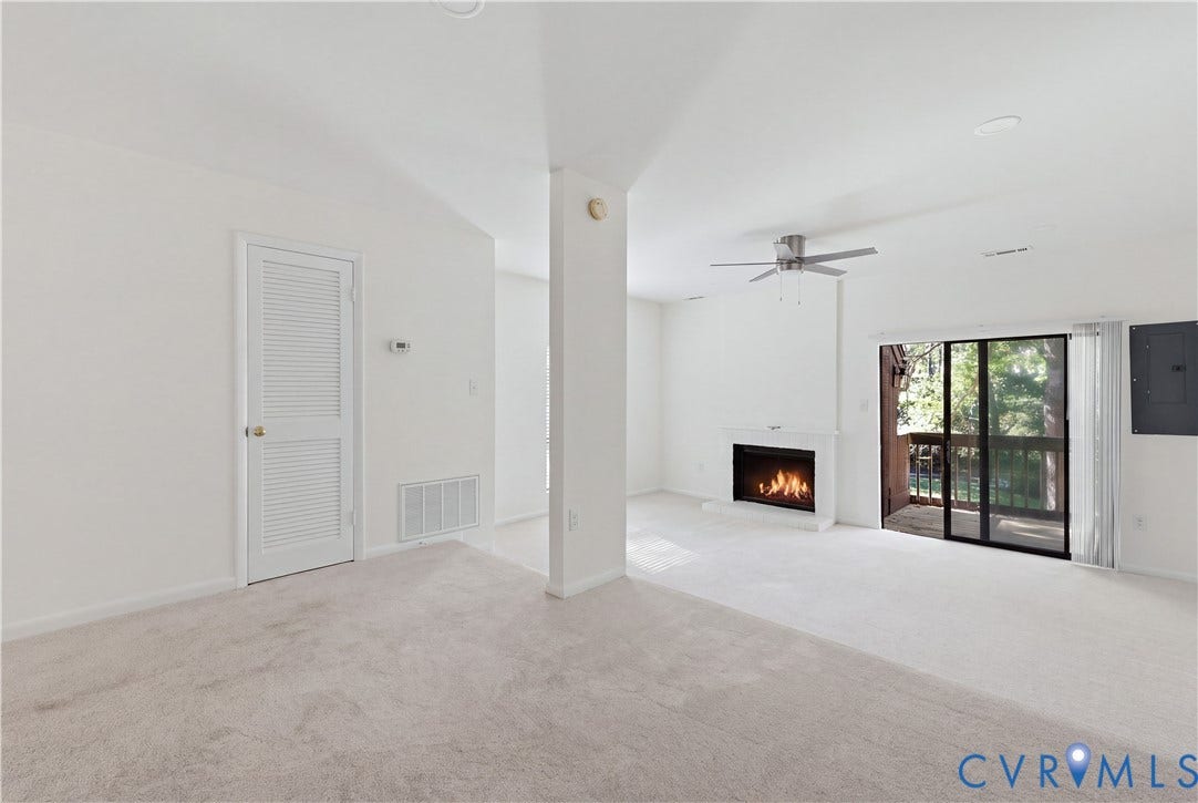11947 W Briar Patch Drive, Chesterfield, VA 23113 Neutral-toned wall-to-wall carpeting, fireplace with a white mantel, sliding glass doors, and a ceiling fan