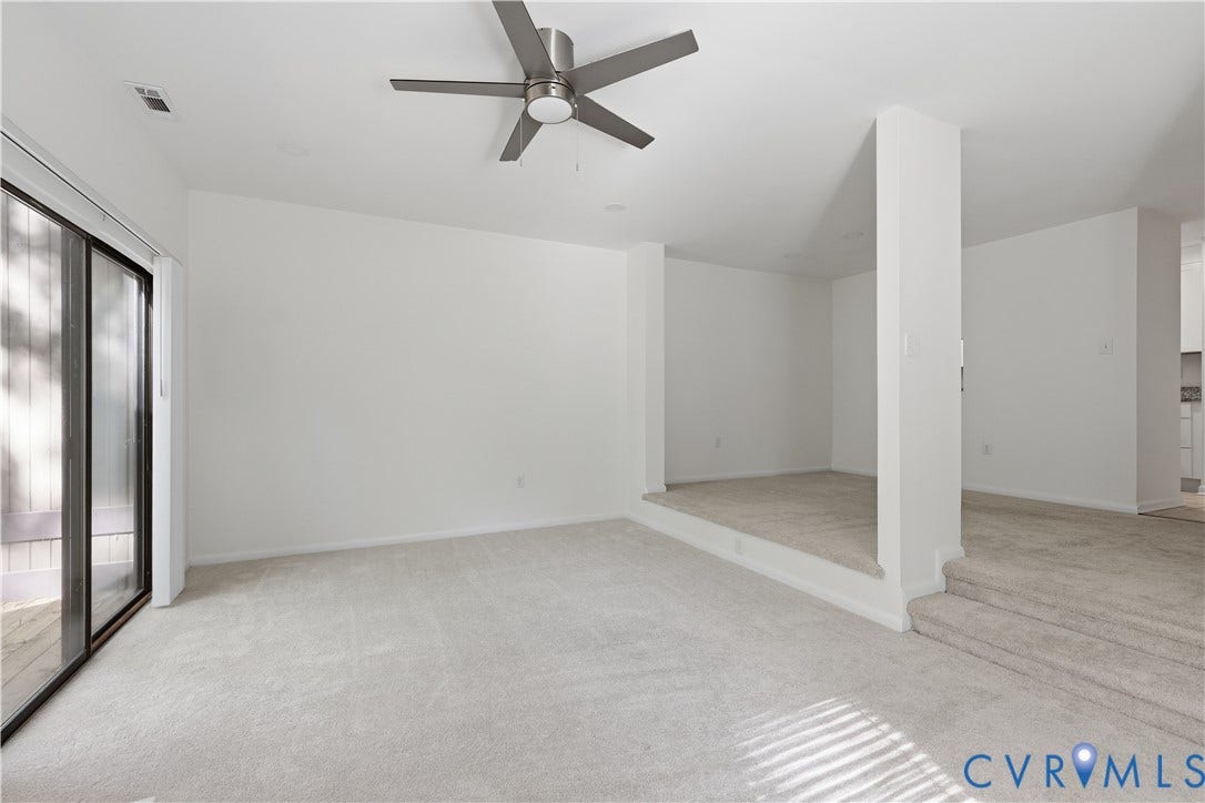 11947 W Briar Patch Drive, Chesterfield, VA 23113 Multi-level floor plan featuring carpeted flooring, a recessed platform area, structural pillars, a ceiling fan with integrated lighting, and sliding glass doors
