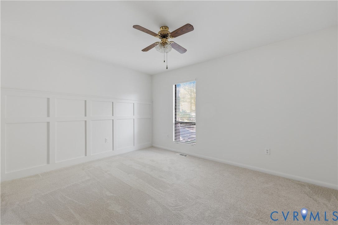 11947 W Briar Patch Drive, Chesterfield, VA 23113 Neutral wall tones, wall wainscoting, wall-to-wall carpeting, and a central ceiling fan with integrated light fixture