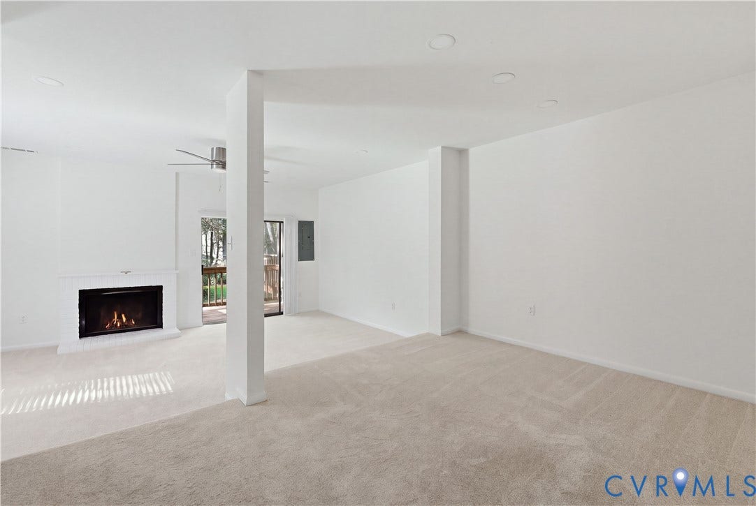 11947 W Briar Patch Drive, Chesterfield, VA 23113 Neutral-toned carpeted flooring, fireplace with a painted masonry surround, recessed lighting, and sliding glass door leading to an outdoor deck