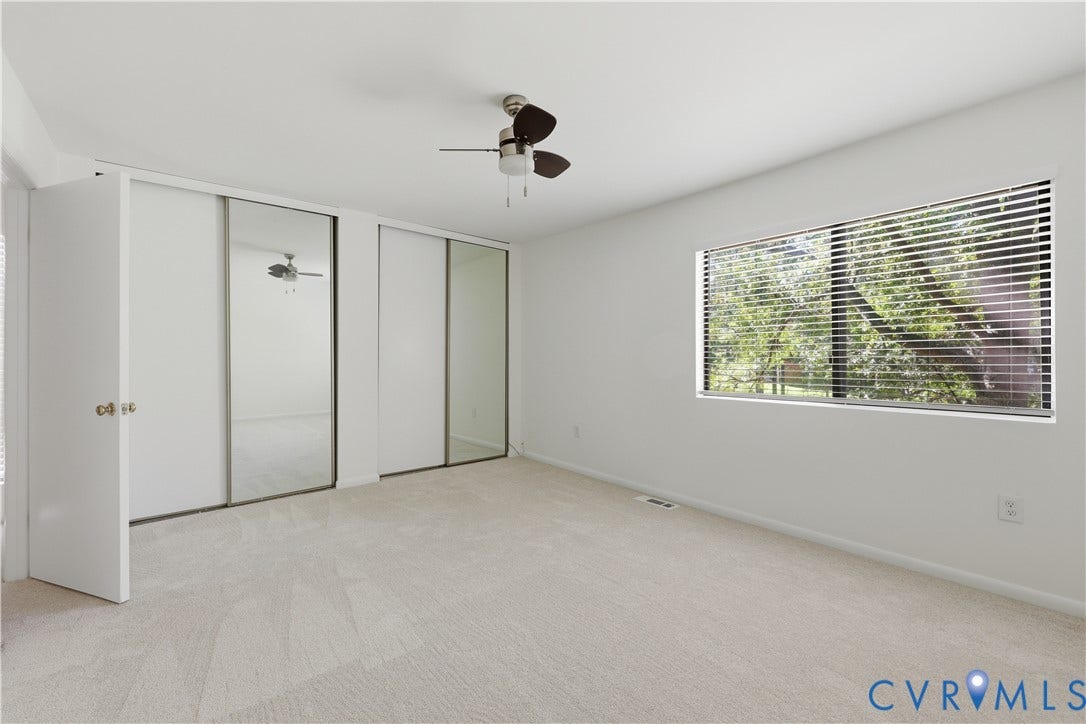 11947 W Briar Patch Drive, Chesterfield, VA 23113 Neutral-toned carpeting, dual sliding mirror-paneled closet doors, and ceiling-mounted fan with integrated light fixture