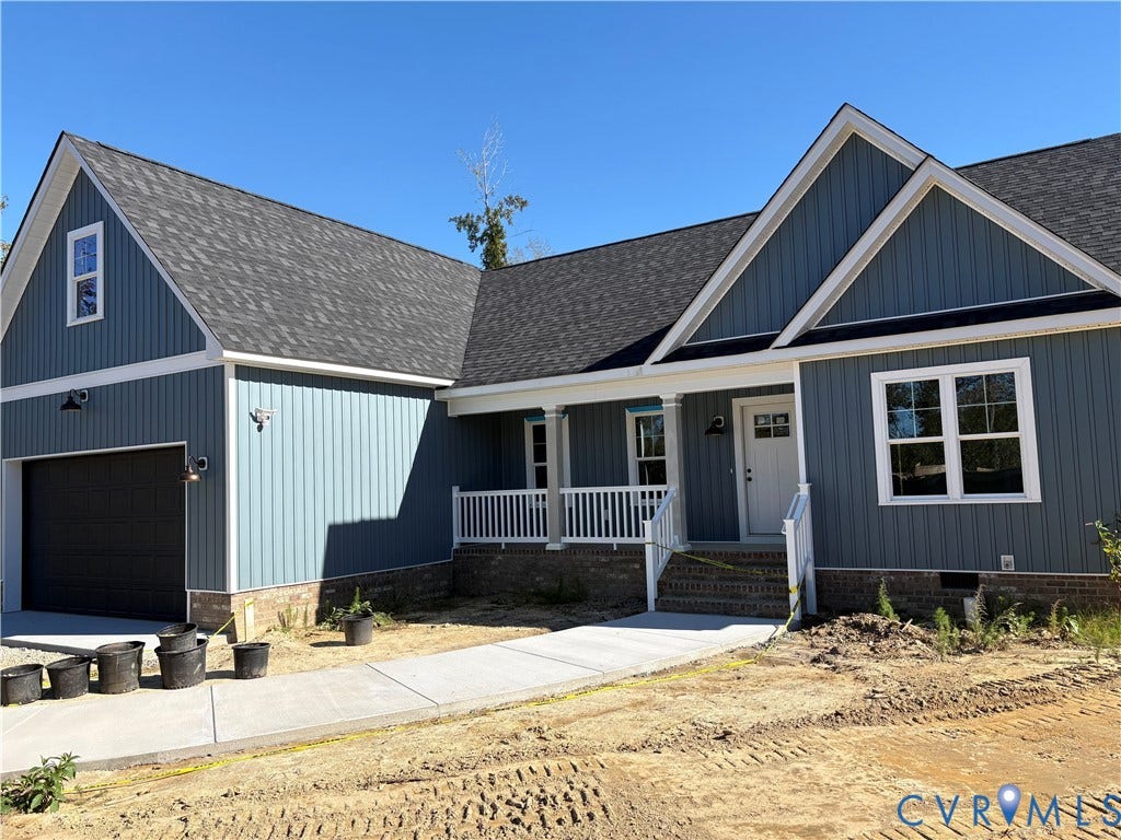 15135 Lebanon, Parson's Retreat, Disputanta, VA 23842 Board-and-batten siding exterior featuring a brick foundation, covered front porch with white railing, multi-gabled roofline, and attached garage